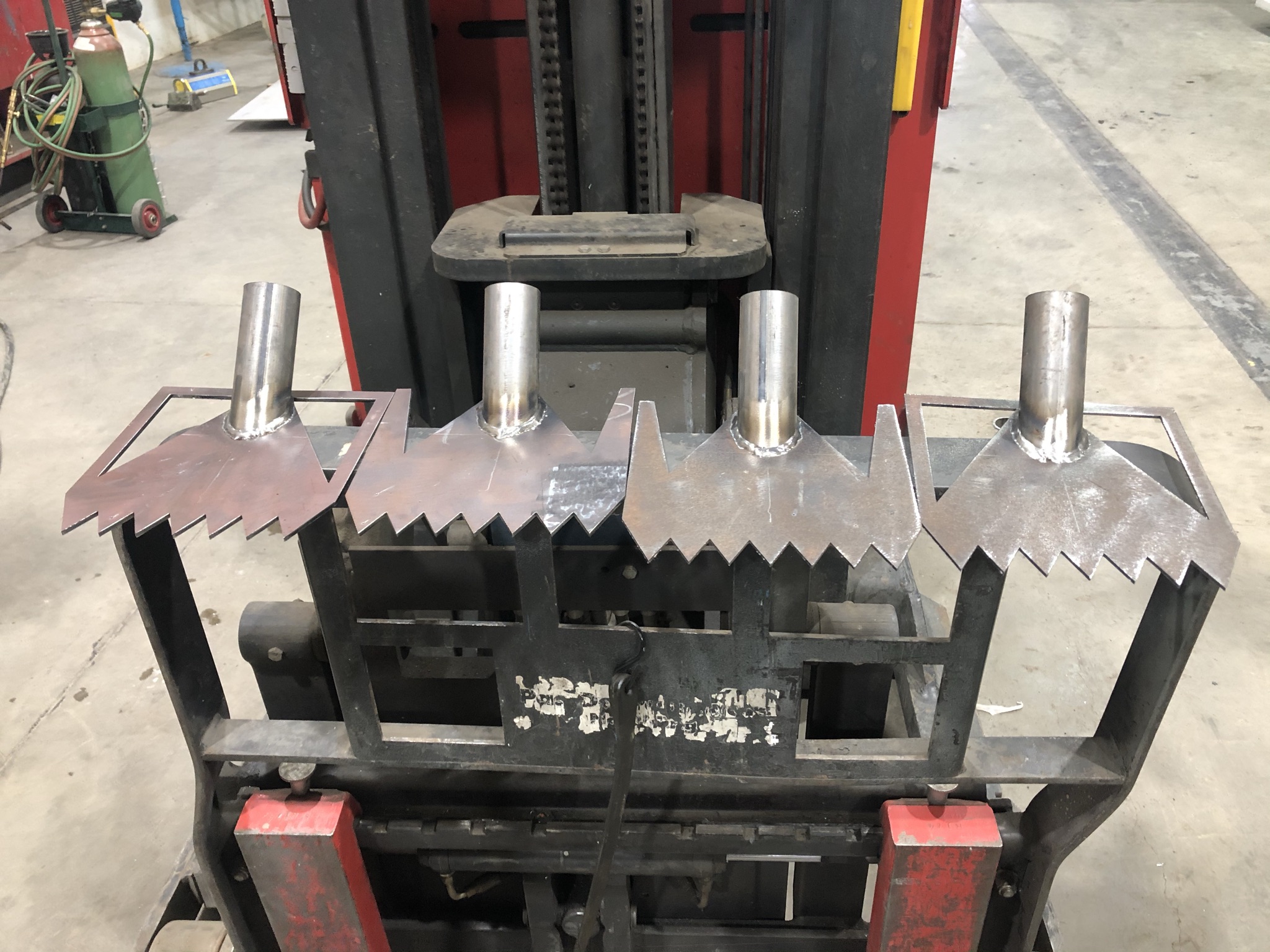 Four iteration heads welded to forklift tines for roof testing