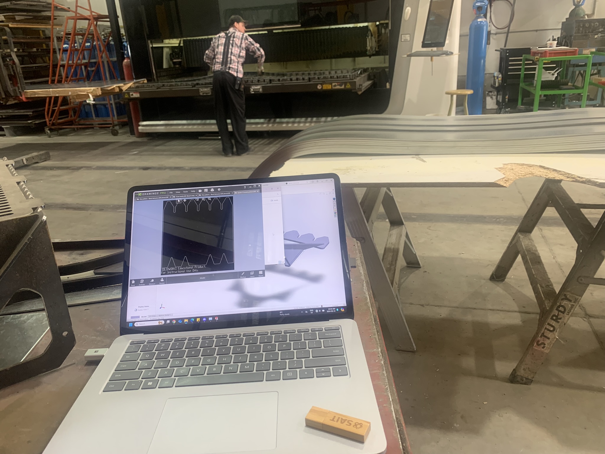 SolidWorks drawings on workshop bench during fabrication